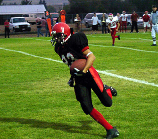 Jake Holthaus heads for the end zone after getting wide open for a pass.
