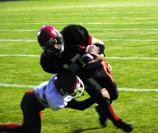 Kyle Holthaus pushes through a tackle attempt for a 2-point conversion.