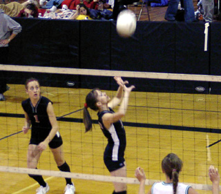 Alli Holthaus sets the ball.
