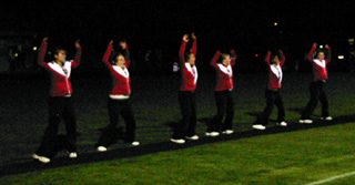 Prairie cheerleaders do a jumping jack for each point on the scoreboard after every Prairie touchdown.