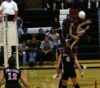 Randi Schumacher reaches back to make a spike against Deary.