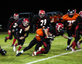 Danny Riener lunges forward as a Kendrick tackler brings him down.