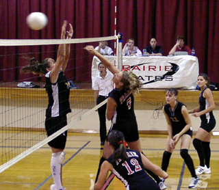 Tessica Nuxoll slams one past a Highland blocker. Also shown are Brooke Holthaus, Alli Holthaus and Nicole Nida.