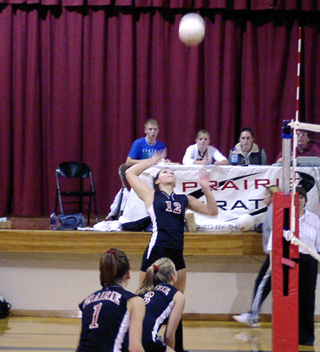 Brooke Holthaus winds up for a big hit against Lapwai. Also shown are Randi Schumacher and Carolyn Sonnen.