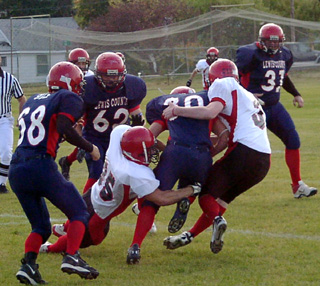 Danny Riener and Tyler Forsmann combine to tackle a Lewis County ballcarrier.