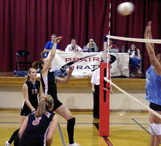 Randi Schumacher spikes the ball over Lapwai's blockers. Also shown are Kylie Uhlorn and Carolyn Sonnen.