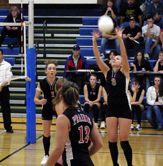 Carolyn Sonnen sets the ball. Also shown from left are Randi Schumacher, Kim Schaeffer and Brooke Holthaus.