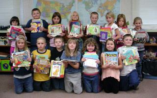 Mrs. Riggers' 2nd grade class shows the books they are donating to orphans in Africa.