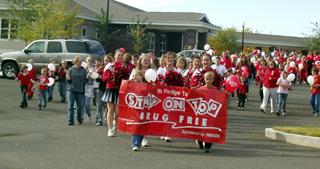 Elementary students along with the high school band and cheerleaders participated in the Red Ribbon Week Parade on Monday.