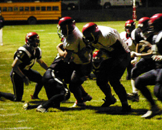 Danny Riener battles toward the end zone. At right is J.D. Riener.