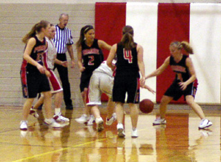 Kylie Uhlorn, Nicole Nida, Jennifer Enneking and Tabitha Sonnen surround a CV player.