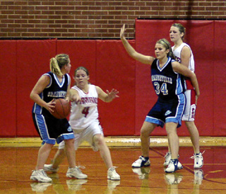 Jennifer Enneking takes a swipe at the ball as Kylie Uhlorn defends in the post against Grangeville.