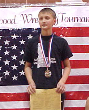 Tayler Heitman on the medal stand after receiving a first place award.