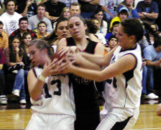 Kaylee Uhlenkott battles for a rebound with a pair of Kamiah players.
