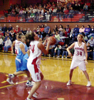Becky Gehring goes for a lay-up. At right is Sarah Arnzen.