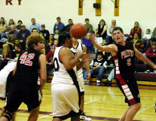 Corey Schaeffer yells as he goes after a loose ball. At left is J.D. Riener.