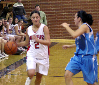 Nicole Nida dribbles up court against Lapwai's Annie Kane.