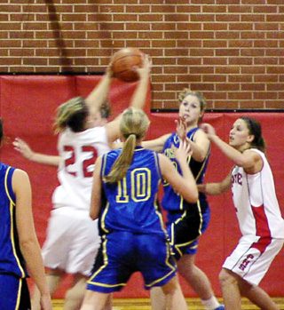 Meghan VanderPas pulls down a defensive rebound as Nicole Nida watches.