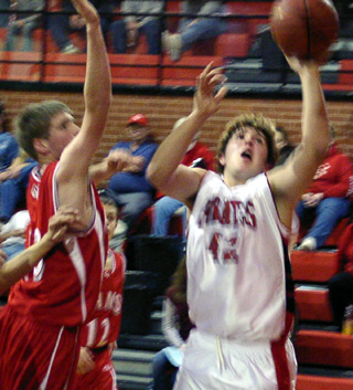 J.D. Riener puts up a shot against C.V.