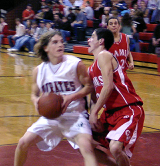Daniel Sigler is about to score a lay-up over a CV defender.