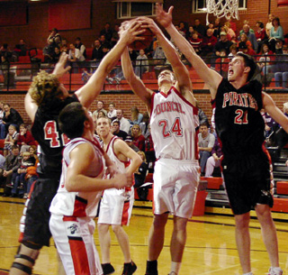 J.D. Riener battles a Council player for a rebound while Corey Schaeffer tries to get a hand into the action.