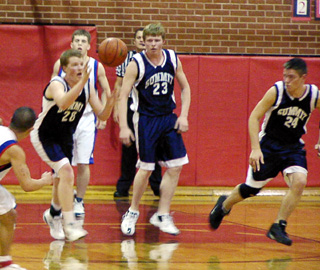 Dustin Lustig goes after a loose ball as Jacob Uhlenkott watches and William Schlader heads upcourt.