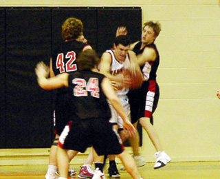 Pirate defenders J.D. Riener, Ryan Daly and Kyle Daly surround a Kendrick player.