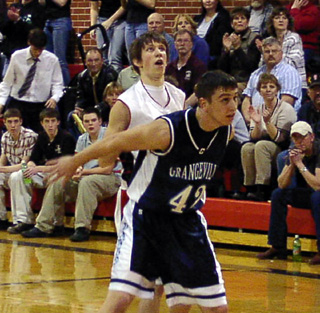Nate Kaschmitter watches his 3-point attempt go through the hoop.