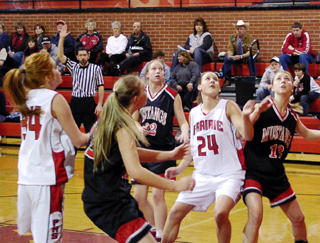 Becky Gehring battles for rebounding position. At left is Sarah Arnzen.