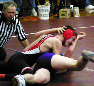Tony Duman gets a hand to the face as he tries to pin this opponent.