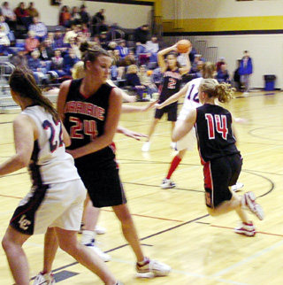 Becky Gehring sets a pick while Tabitha Sonnen goes through the lane behind her. Nicole Nida looks to make a pass inthe background.