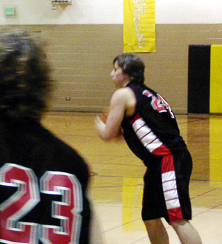 Ryan Daly makes a pass. Also shown is David Sigler.