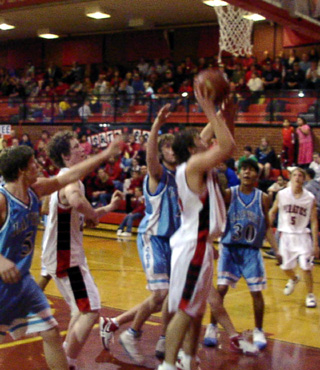 Ryan Daly goes for a lay-up. At left is Tyler Forsmann with Kyle Daly int he background.