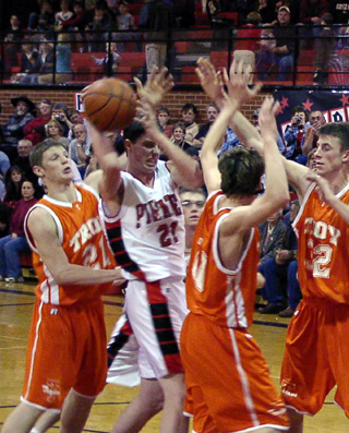 Corey Schaeffer battles several Troy players for a rebound.