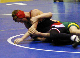 Ronald George is about to pin his opponent.