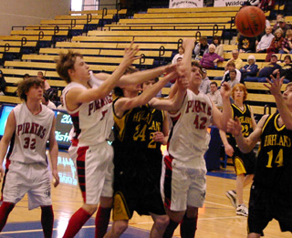 It's a battle for a loose ball. From left are Branden Waller, Kyle Daly and J.D. Riener.