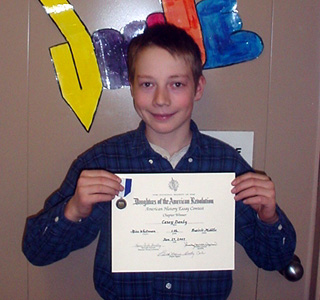 Casey Danly with his certificate for winning the DAR essay contest.