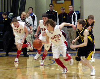 David Sigler ignites a fast break after a Highland turnover. At left are Tyler Forsmann and Corey Schaeffer.