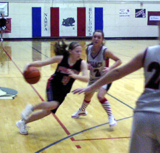 Jennifer Enneking drives toward the lane against Wallace.