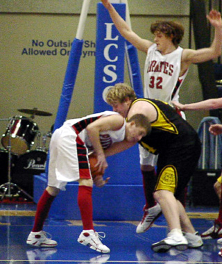 Kyle Holthaus battles a Highland player for the ball as Branden Waller swoops in.