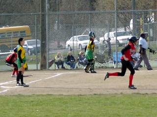 Kim Schaeffer heads for second on a run-scoring hit against Lakeland.