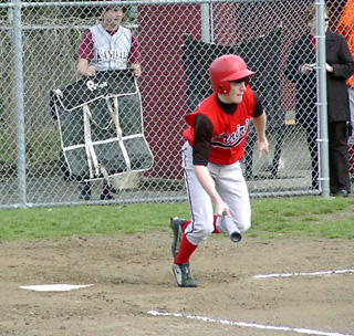 Kyle Holthaus heads for first after making contact at Kamiah.