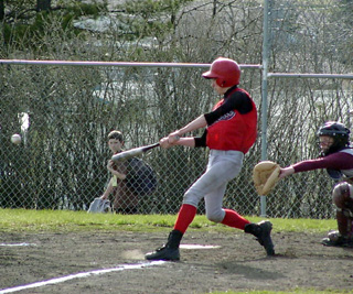 Nate Kaschmitter is about to connect with a pitch in the Kamiah game.