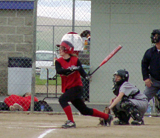 Kara Guyer watches her long drive head for the fence. She wound up with a triple.