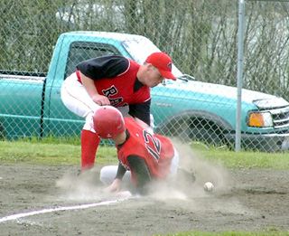 Eric Daly slides into home with a run after a passed ball.