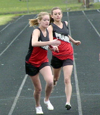 Katie Nuxoll, left, receives the baton from Gina Holthaus in the medley relay.
