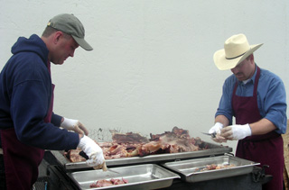 Matt Beckman and Norm Sonnen cooking the pork for the potluck dinner.