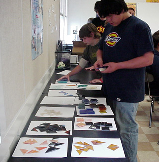 J.C. Enriquez picks out stained glass pieces.