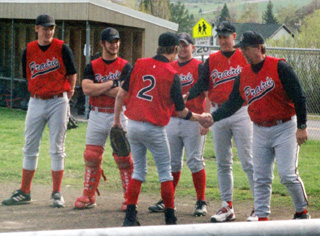 Nate Kaschmitter shakes hands with head coach Pat Holthaus during Senior Night ceremonies. Other seniors already honored from left are Ben Forsmann, Dan Riener and Ben Schumacher with coaches Jerry Uhling and Pat Holthaus.