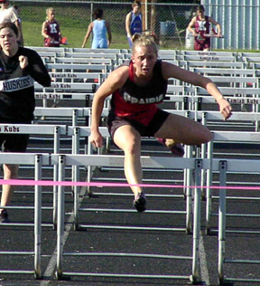 Tabitha Sonnen clears the final hurdle in the 100 hurdles prelims. She broke a long-standing school record in the prelim heat.